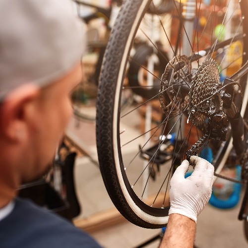 Mechanic repairing bicycle in his workshop